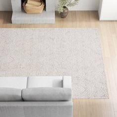 an overhead view of a living room with a couch, fireplace and rug in it