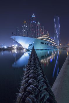 a cruise ship docked in the harbor at night