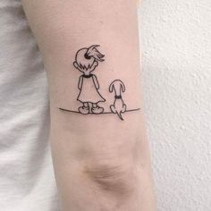 a woman with a dog on her arm is holding the hand of a man that has a small tattoo