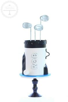 a white and black toaster sitting on top of a blue stand with spoons sticking out of it