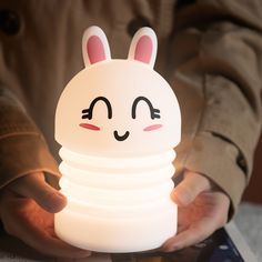 a person holding a light up in the shape of a bunny