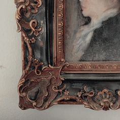 an ornate frame with a woman's face painted on it