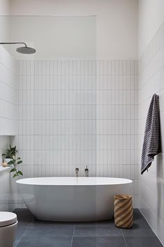 a white bath tub sitting next to a toilet