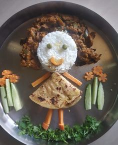 a plate that has food on it with an image of a person made out of meat and vegetables