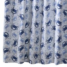 a blue and white shower curtain with crabs on it