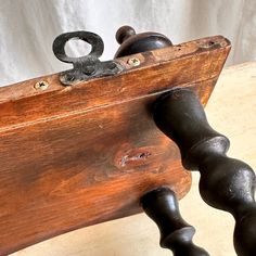 an old wooden bench with metal handles on it