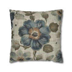 a blue flower pillow on a white background