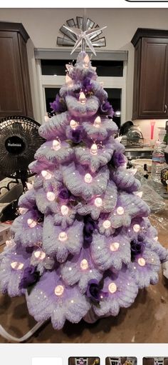 a purple christmas tree with lights on it