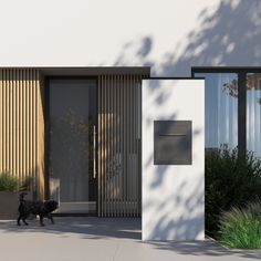 a black dog is walking in front of a building with large glass doors and plants