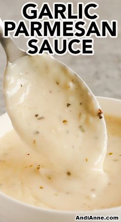 garlic parmesan sauce in a white bowl with a spoon full of gravy