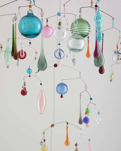 an assortment of colorful glass items hanging from a ceiling