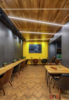 an empty conference room with wooden tables and chairs