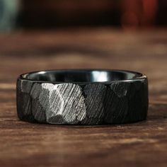 a black and white ring sitting on top of a wooden table