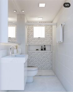 a white bathroom with two sinks and a toilet