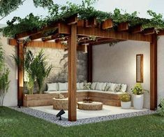 an outdoor living area with couches and potted plants on the side of it