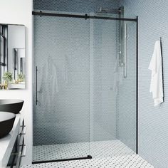 a bathroom with a glass shower door next to a sink