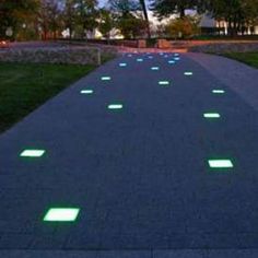 glow in the dark walkway at dusk with trees and buildings in the backround