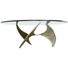 a glass table with two metal birds on it