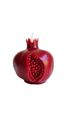 a red pomegranate cut in half on a white background with clippings