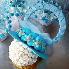 there is a cake with blue and white decorations on the top, along with other items