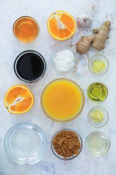 the ingredients for an orange juice are arranged in bowls