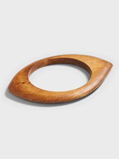 Add an enticing touch and reconnect with the natural world with this hand carved wood bangle.  Interior diameter: 2. 5" (6. 35cm) Natural Wood Bracelet, Wood Pendants, Modernist Jewelry, The Natural World, Wood Pendant, Hand Carved Wood, Carved Wood, The Natural, Natural World