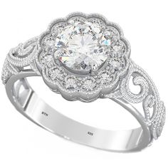 a white gold ring with an intricate design and round brilliant cut diamond center surrounded by pave diamonds