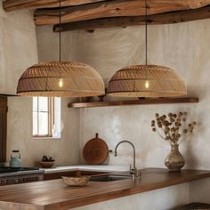 two lights hanging from the ceiling in a kitchen