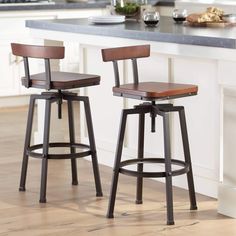 two stools sit in front of a kitchen island