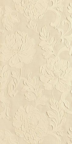 a white wallpaper with flowers and leaves on it