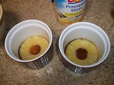 three cups filled with pineapple slices on top of a counter