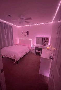 a bedroom with pink walls and lights on the ceiling