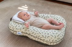 a baby laying on top of a bean bag chair