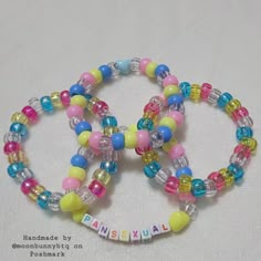 two colorful bracelets with words on them