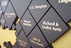 a group of black and white business cards on a wall