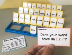 a person holding up a card with words on it next to a keyboard and some cards