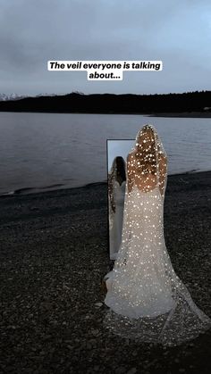 a woman standing in front of a mirror with the caption, the veil everyone is talking about