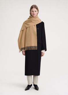 Classic TOTEME scarf made in Italy from responsibly sourced wool. It has a rectangular shape measuring 220x50cm with fringed edges and a monogram label. Wear it throughout winter over your favorite coat or jacket. Luxury Beige Scarf For Fall, Classic Beige Scarf For Fall, Classic Beige Scarves For Fall, Beige Wool Scarves For Winter, Classic Beige Shawl For Winter, Beige Wool Shawl For Winter, Beige Wool Winter Shawl, Elegant Beige Wool Scarf, Classic Shawl Scarf For Fall