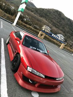 a red sports car parked in a parking lot