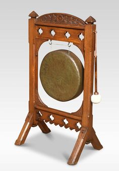 an old fashioned wooden clock with pendulums on it's sides and the back side showing