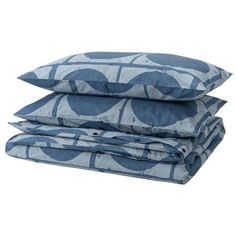 three pillows stacked on top of each other in front of a white background with blue circles