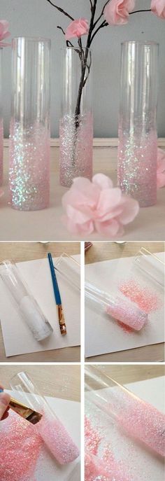 some pink flowers are in vases on a table with paper and paintbrushes