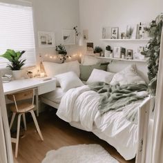 a white bed sitting next to a desk in a room with lots of lights on it