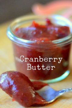 cranberry butter in a glass jar with a spoon