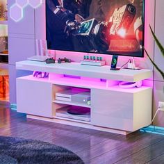 a flat screen tv sitting on top of a white entertainment center