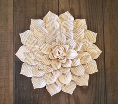 a paper flower made out of old book pages