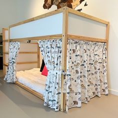 a bed with curtains on the top and bottom