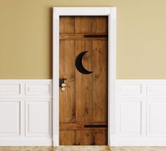 an open door with the moon and crescent symbol on it in a white walled room