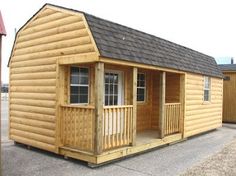 a small wooden cabin sitting on top of a parking lot