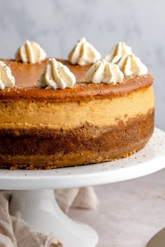 a close up of a cake on a plate with icing and whipped cream toppings